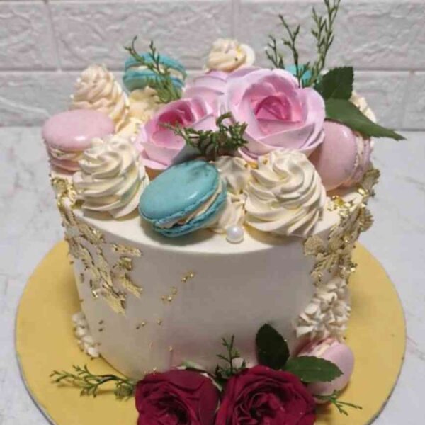 floral designer cake Chennai with roses, macarons and gold leaf finish