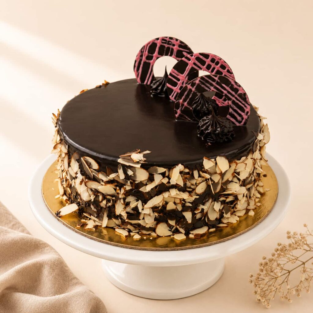Choco Almond Cake with rich chocolate sponge, smooth chocolate cream, and premium roasted almonds, available for online cake delivery in Chennai from Heydudes Cake Cafe.