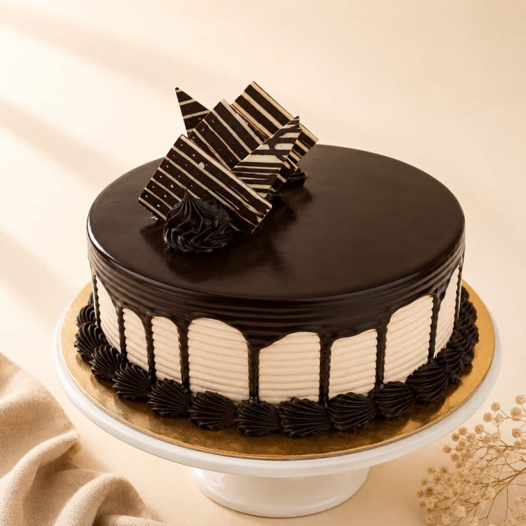 Choco Fudge Cake with moist chocolate sponge, rich fudge frosting, and smooth chocolate ganache, available for online cake delivery in Chennai from Heydudes Cake Cafe.