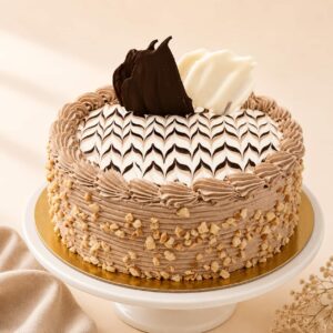 Nutty Chocolate Cake topped with premium roasted nuts and rich chocolate, available for online cake delivery in Chennai from Heydudes Cake Cafe.