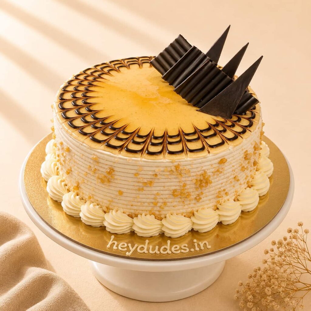 Butterscotch Cake with soft vanilla sponge, creamy butterscotch frosting, caramel drizzle, and crunchy butterscotch bits, available for online cake delivery in Chennai from Heydudes Cake Cafe.